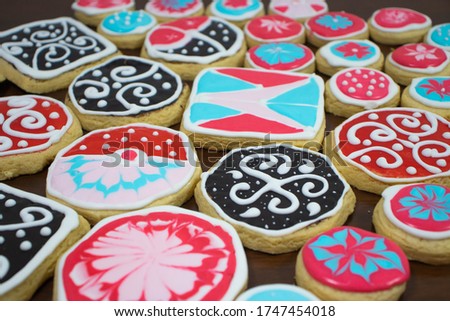 Colourful Homemade Dessert  with kids art decoration. Glazed icing cookies isolated on wooden table.