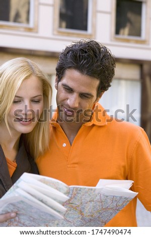 Couple reading map in urban area