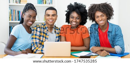 Group photo of south american students at computer at classroom of university