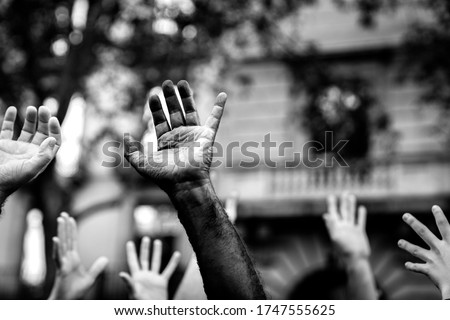 Multicultural hands raised in the air asking for freedom. Stop racism. Stop repression. Royalty-Free Stock Photo #1747555625