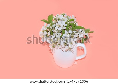 Abstract floral arrangement,composition, flowering cherry branches in a mug, place for text. Creative modern bouquet, minimal holiday concept. Flower card, spring banner