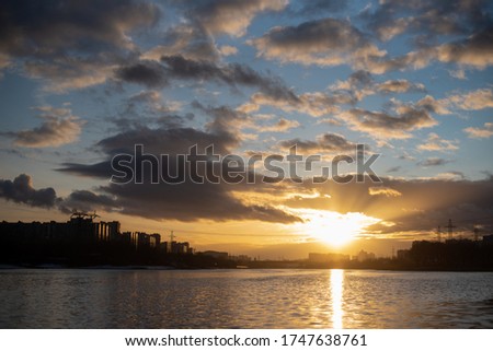 There is the wonderful sunset under the river Moscow. The clouds are around