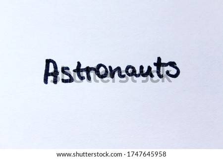 Astronauts. Handwritten word on a white background.