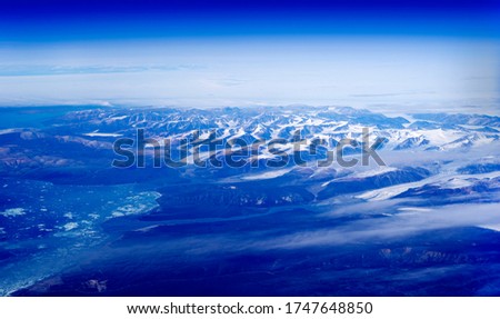 Baffin Bay sea and Greenland coastal mountains in blue morning
