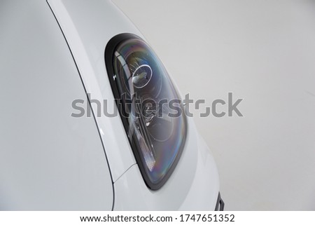 Close up of headlight on a white sports car
