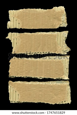 Brown and beige corrugated cardboard pieces, isolated on black background