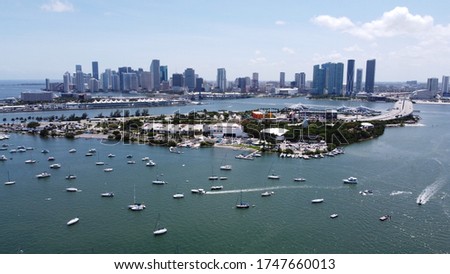 View of boats in marinas and harbors in biscayne bay, Miami. Drone footage showing water, city skyline and boats