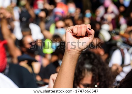 White hand on a black rights demonstration. White and black people together. Anti racism in the USA. Human rights, freedom and justice. Demonstration Fight Royalty-Free Stock Photo #1747666547