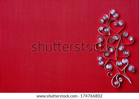 Quilling paper on red cardboard. Background with hearts for Valentine's day.