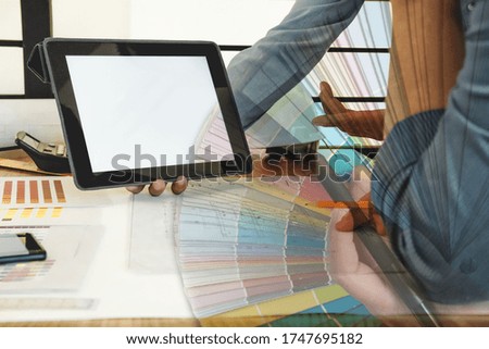 architect interior designer working with architectural drawing of house & color swatch catalog