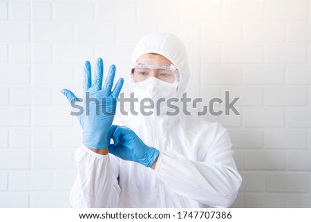 Medical healthcare scientist doctor wearing goggles blue latex gloves protection from bacterial infection virus safety clean sanitize, lab suit protective overall hospital laboratory white background 