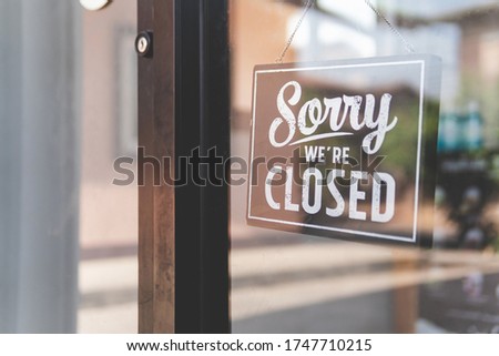 Label 'Sorry we're closed' notice sign wood board hanging on door front coffee shop. Royalty-Free Stock Photo #1747710215