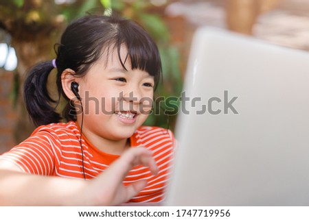 Asian girl student online learning class study online video call zoom teacher, Happy girl learn english language online with laptop at home.New normal.Covid-19 coronavirus.Social distancing.stay home Royalty-Free Stock Photo #1747719956