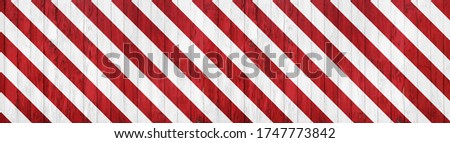 banner of wooden boarding painted red and white restricted area marking