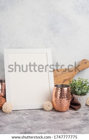 On a light background, a white empty frame, on the background of kitchen utensils. Advertising or banner for inscriptions, fonts, logos. Cooking, cooking.