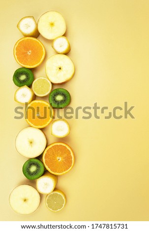Background for text made of fruits. Sliced fruits and apple in the shape of a star. Apple, Banana, Kiwi, Lemon, Orange, Citrus