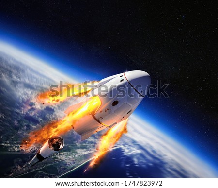 Crew Dragon spacecraft of the private American company SpaceX in space. Dragon is capable of carrying up to 7 passengers to and from Earth orbit, and beyond. Elements of this image furnished by NASA. Royalty-Free Stock Photo #1747823972