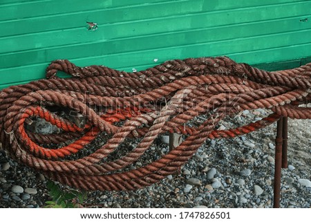 Red sea ropes. Wet cables by the sea. Ropes for fastening. For seafarers. High quality photo