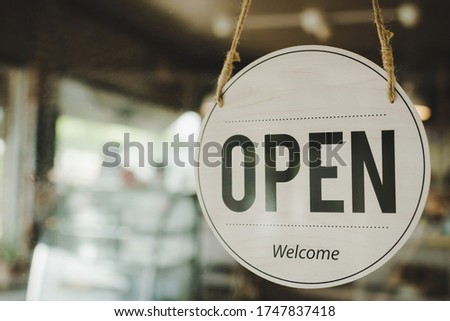 Open. coffee cafe shop text on vintage sign board hanging on glass door in modern cafe coffee shop, cafe restaurant, retail store, small business owner, takeaway food, food and drink concept