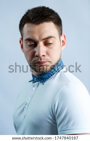 Portrait of a man in a white polo on a white background. Male image for every day. Stylish guy