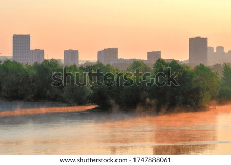 Houses and trees on the river Bank. 
