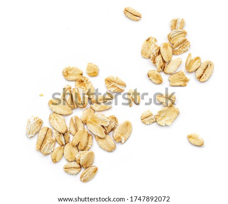 Oat flakes isolated on white background. Pile of oatmeal  top view Royalty-Free Stock Photo #1747892072