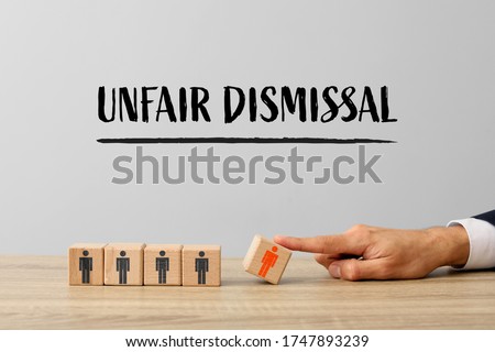 Businessman removing wooden cube with drawn human figure from table. Concept of unfair dismissal Royalty-Free Stock Photo #1747893239