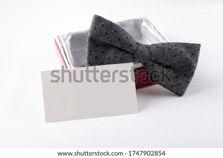 Empty paper card, bow tie and present box. Fathers day and greeting card concept. Business card concept
