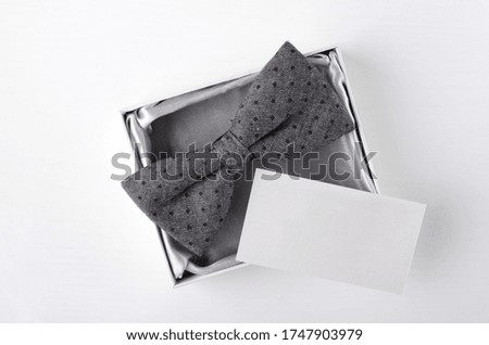 Top view of empty business card, bow tie in the present box.Concept of happy fathers day or business card presentation