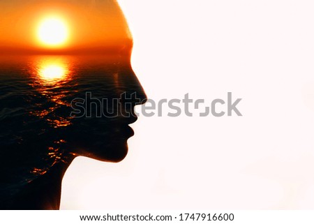 Woman head silhouette with sun inside with copy space. Multiple exposure image. Royalty-Free Stock Photo #1747916600