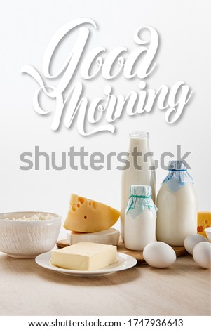 various fresh organic dairy products and eggs on wooden table isolated on white, good morning illustration