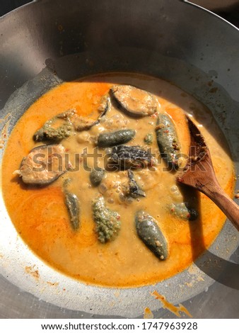 Catfish curry in a metal pan.