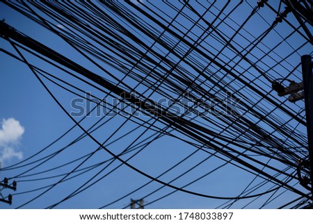 The mess electrical wires with the sky background
