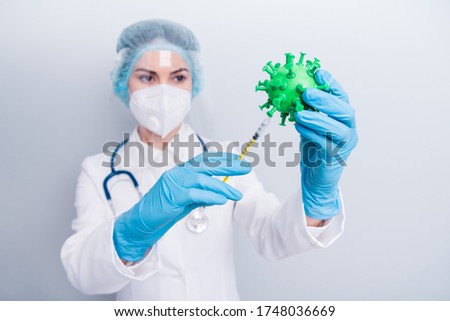 Closeup photo of serious lady doc working covid bacteria analyzing trying new experimental vaccine injection wear gloves mask coat facial plastic surgical cap isolated grey color background Royalty-Free Stock Photo #1748036669