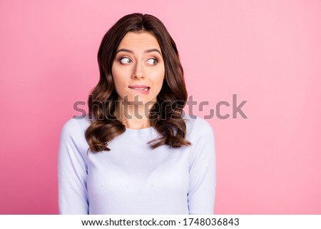 Photo of attractive lady wavy hairdo biting lips look shy side empty space made wrong bad thing uncomfortable situation wear casual white pullover isolated pink color background Royalty-Free Stock Photo #1748036843