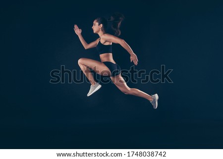 Full size profile photo short sport suit lady sprint run jogger wide steps professional inspired to win race first place isolated black background