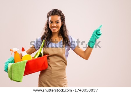 Portrait of african-american professional maid who is ready for housework.