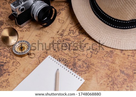 Compass and accessories on map for travel planning