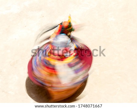 Monk in a bull deity mask performs a religious masked and costumed dance of Tantric Tibetan Buddhism on Cham Dance (Yuru Kabgyat) Festival in Lamayuru monastery, India. Blurred motion, view from above