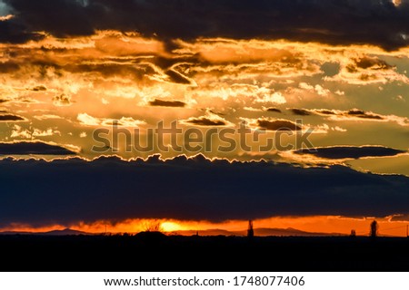 Amazing sunset sky with clouds and rays of light in the north Italy close to the delta Po river