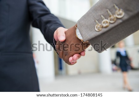 African businessman's hand shaking white businessman's hand  making a business deal. Royalty-Free Stock Photo #174808145