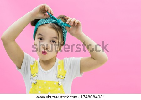 Little child girl in white shirt on pink background.