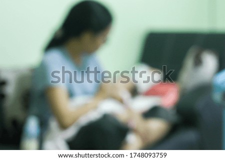 Blur picture of new born baby lay down  on parents lap. Concept for love,happy family,parenthood and breastfeeding.