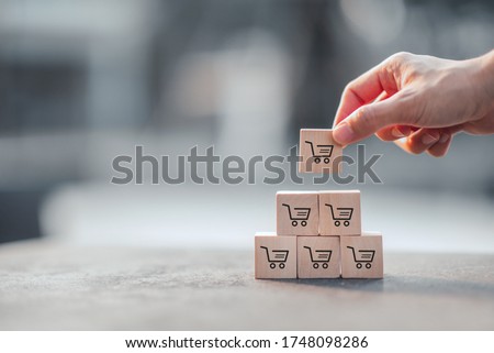 Sale volume increase make business grow, Wood cube with icon graph and shopping cart symbol. Royalty-Free Stock Photo #1748098286