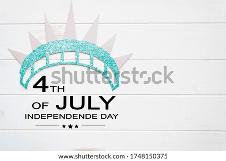Statue of liberty crown on white wooden table with the text 4th of July,Independence day