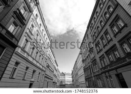 Prague, black and white picture of street with lines and perspective of residential buildings, horizon with sky