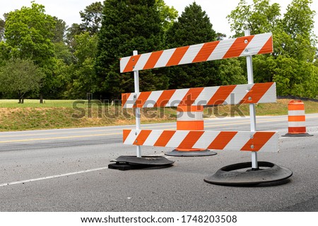 Orange and white striped road barricade, detour for street construction, horizontal aspect