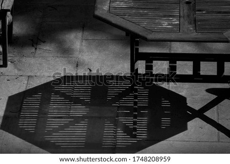 Garden table casting shadow on patio