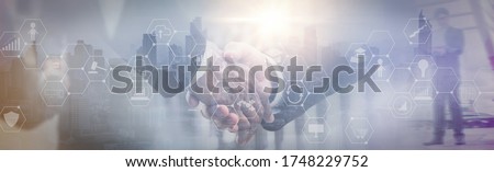 Mixed media effect Double exposure,businessman handshake deal to partner,successfully negotiated and commercial cooperation,business icon and diagrams chart,cityscape background,website header banner