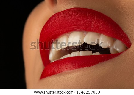 Beautiful red lips with white letters on a black background.